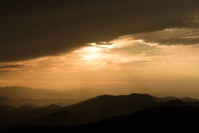 Scenic view of silhouette mountains against sky during sunset