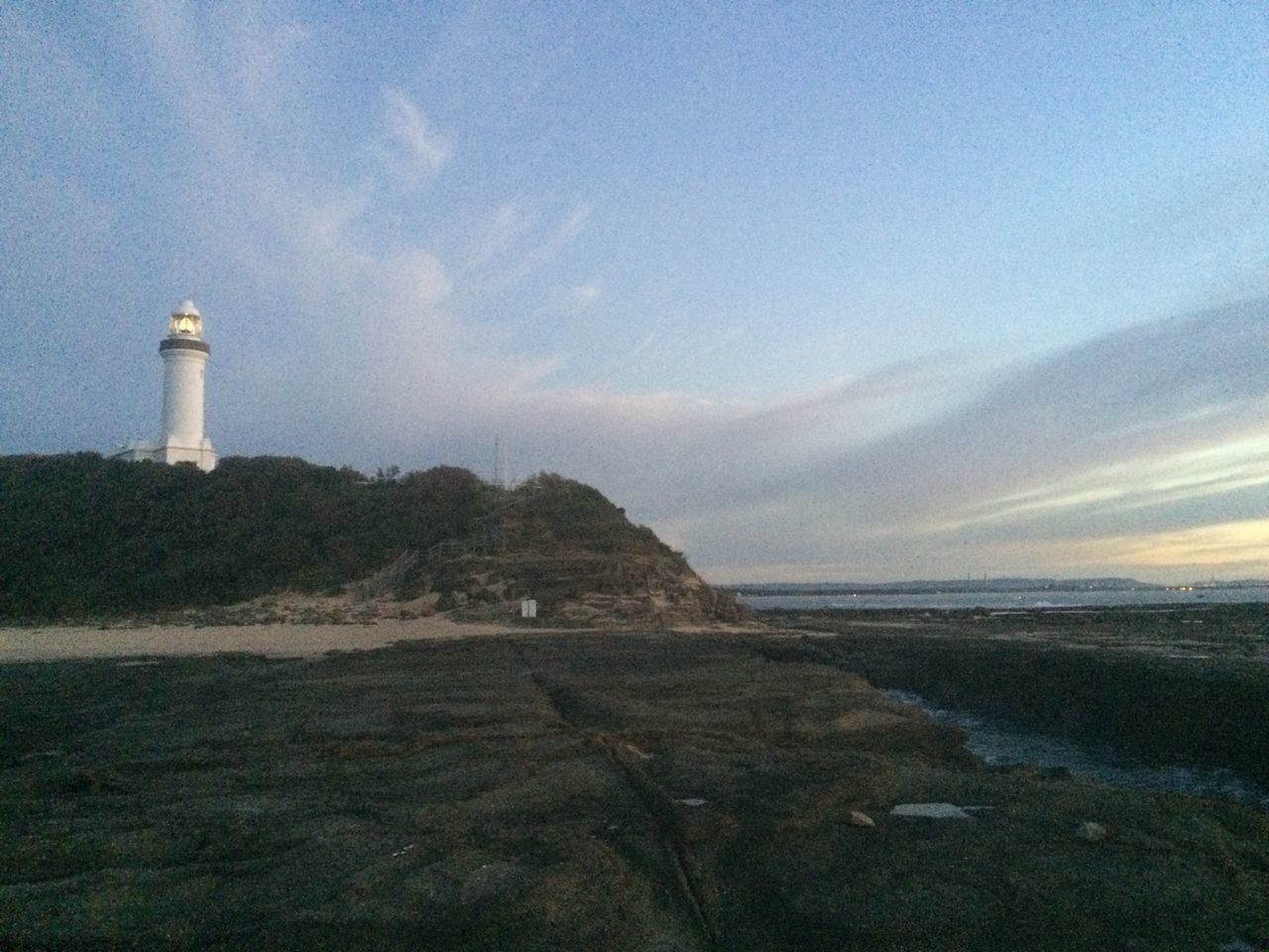 lighthouse, guidance, sea, sky, architecture, built structure, building exterior, water, scenics, direction, tranquil scene, tranquility, horizon over water, tower, protection, beauty in nature, nature, beach, safety, rock - object