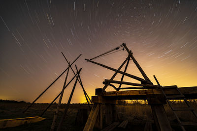 Low angle view of star trails against sky at night