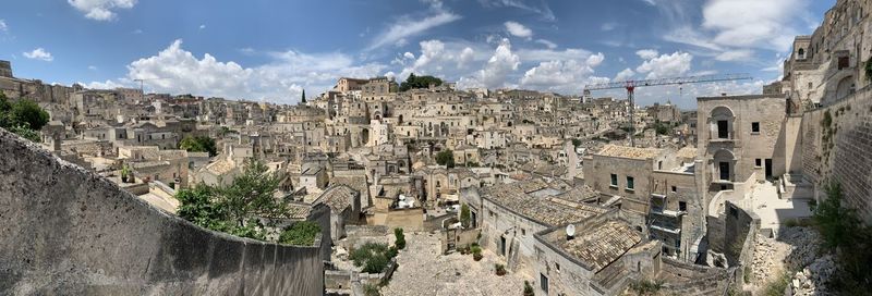 Panoramic view of buildings in town against sky