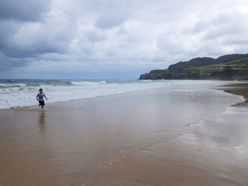 Scenic view of sea against sky. boy on the beach