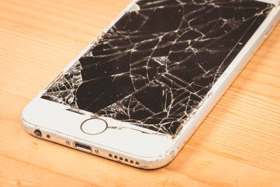 High angle view of broken smart phone on table