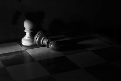 Close-up of chess pieces on floor