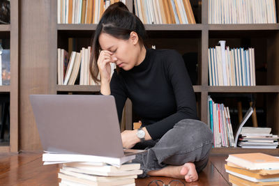 Young woman using laptop at table