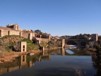 Bridge over river with buildings in background