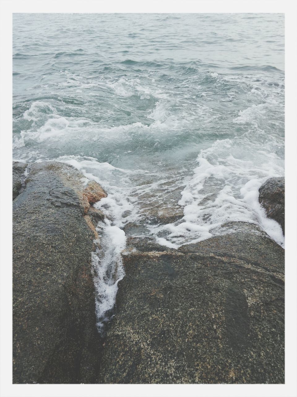 water, sea, transfer print, surf, wave, beach, shore, auto post production filter, nature, beauty in nature, tranquility, scenics, tranquil scene, high angle view, motion, rock - object, horizon over water, sand, day, outdoors