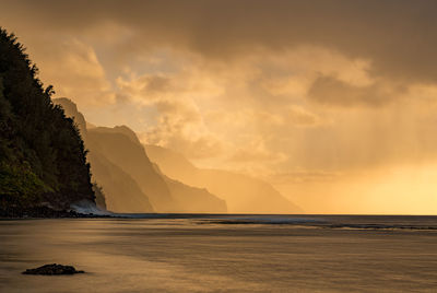 Sunset lights the receding cliffs of the napali coastline on north coast of kauai in hawaii