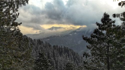 Scenic view of mountains against cloudy sky