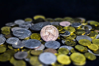 High angle view of coins on black background