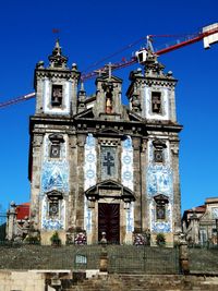 Low angle view of historical building against clear blue sky