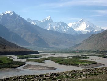 Scenic view of mountains against cloudy sky