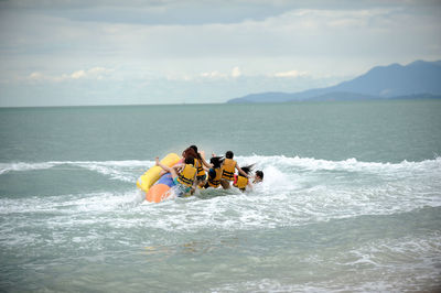 People kayaking in sea