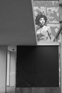 Portrait of woman against wall