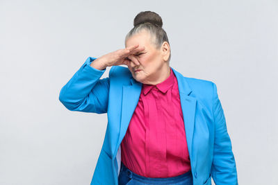 Mid adult man standing against white background