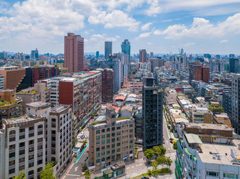 High angle view of buildings in city against sky