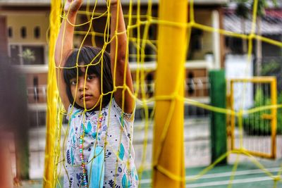 Portrait of young woman standing in playground