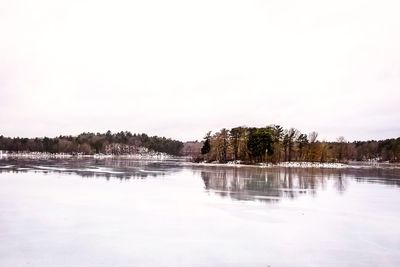 Scenic view of lake against sky during winter