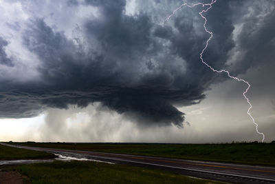 Scenic view of storm clouds over road