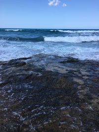 Scenic view of sea against cloudy sky