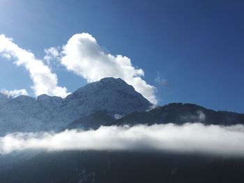 Scenic view of mountains against blue sky