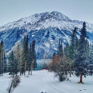 Snow covered landscape against clear sky