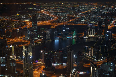 High angle view of illuminated buildings in city at night