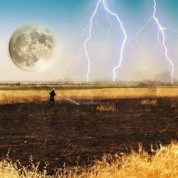 Scenic view of grassy field against sky at night