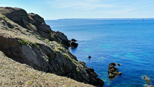 Scenic view of coast and sea against sky