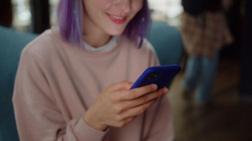 Midsection of woman using mobile phone