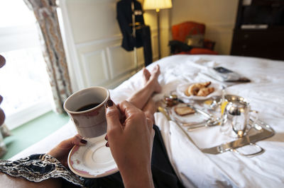 Cropped hand of person preparing food on table