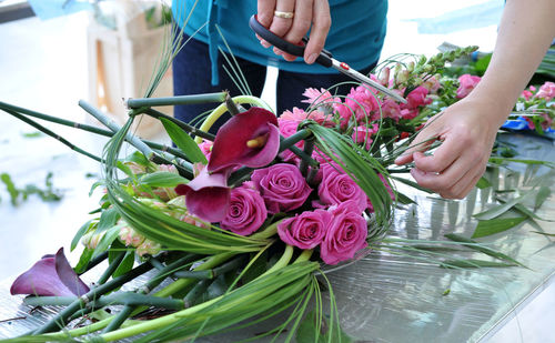 Close-up of florist making bouquet at table