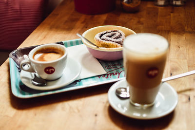 High angle view of coffee and cup on table