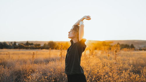 Man standing on field against sky