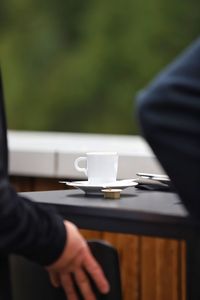 Midsection of businessman using laptop at office