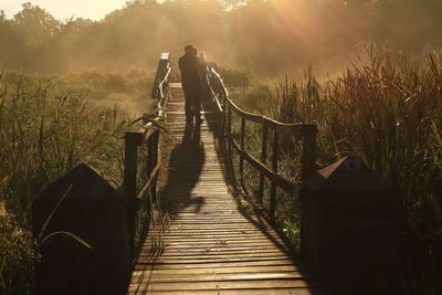 Rear view of men on footbridge