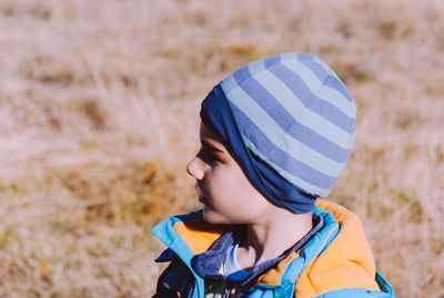 Side view of boy standing on field