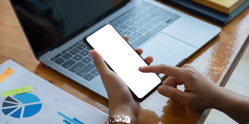 Low angle view of woman using mobile phone