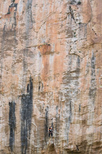 Full length of man climbing on rock formation