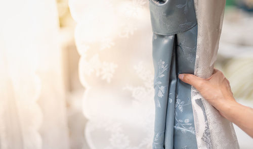 Close-up of hand holding white background