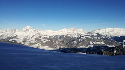 Snowcapped mountains against blue sky