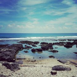 Scenic view of sea against cloudy sky