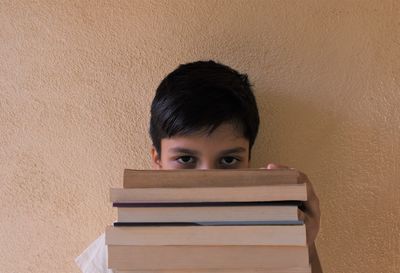 Portrait of boy sitting on book