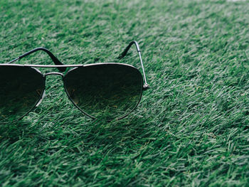 Close-up of sunglasses on field