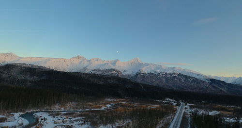 Scenic view of snowcapped mountains against clear sky