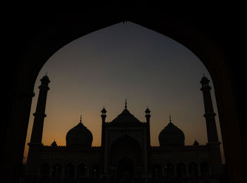 Silhouette of building against sky during sunset