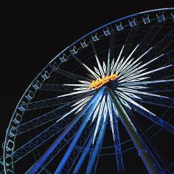 Low angle view of ferris wheel against sky at night