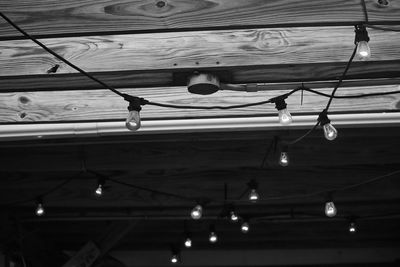 Low angle view of light bulbs hanging on ceiling