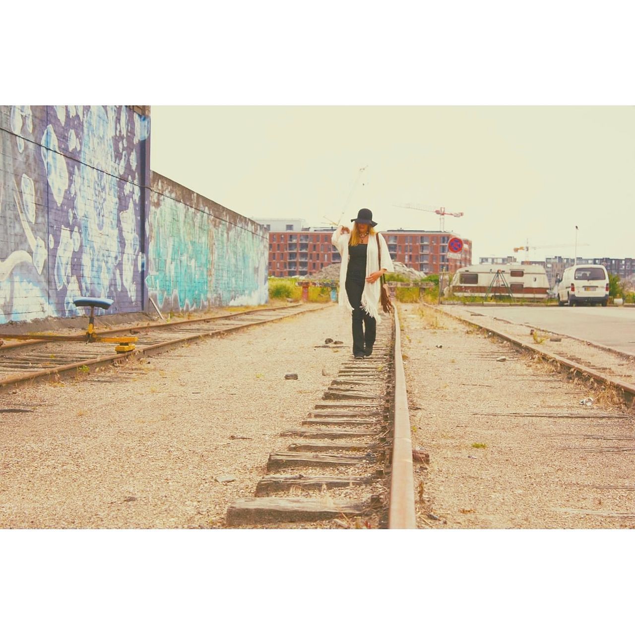 FULL LENGTH REAR VIEW OF MAN STANDING ON WALKWAY