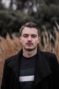Portrait of young man standing outdoors