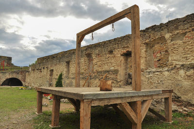 Built structure on field against sky